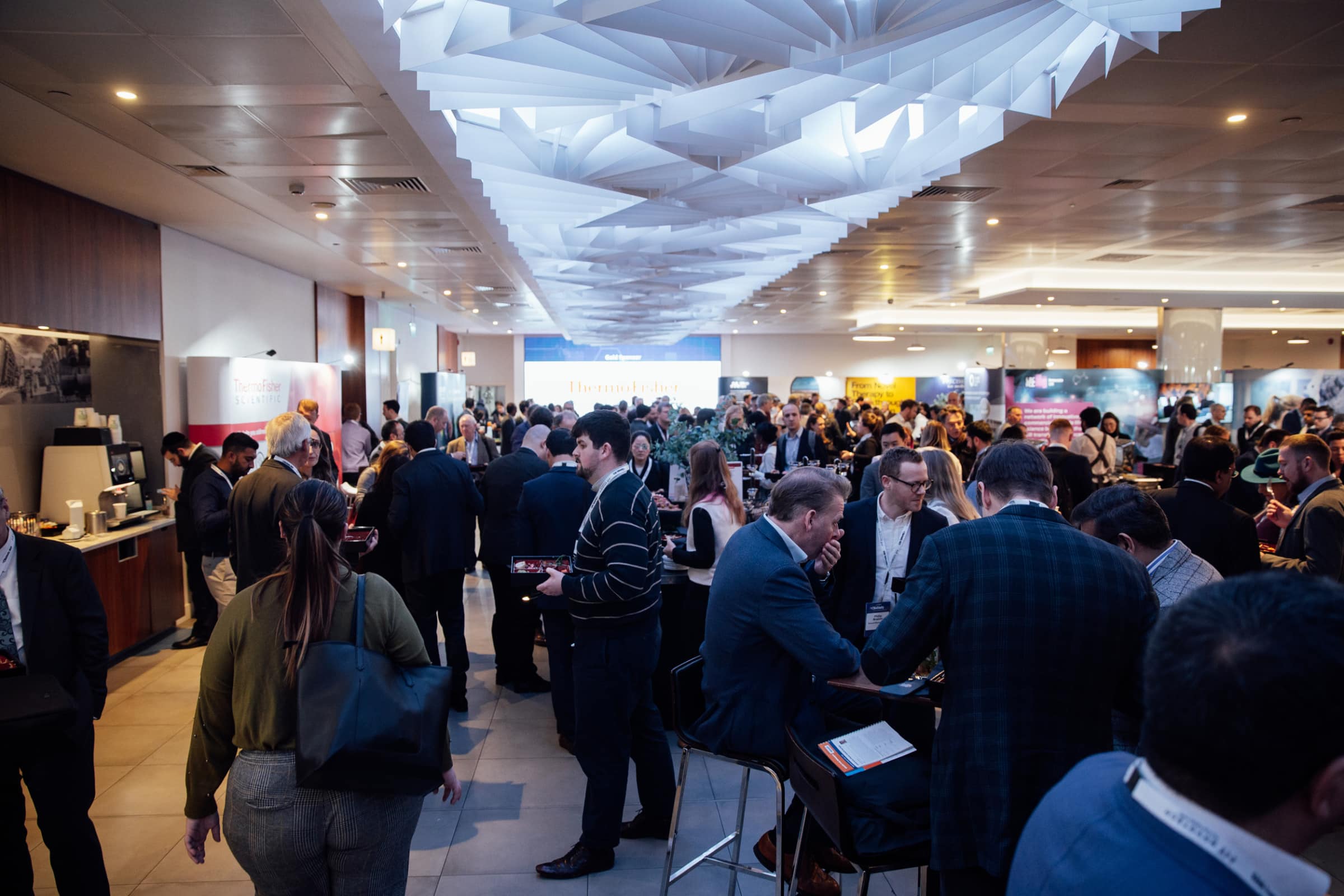 Photograph of lots of people networking at a conference.