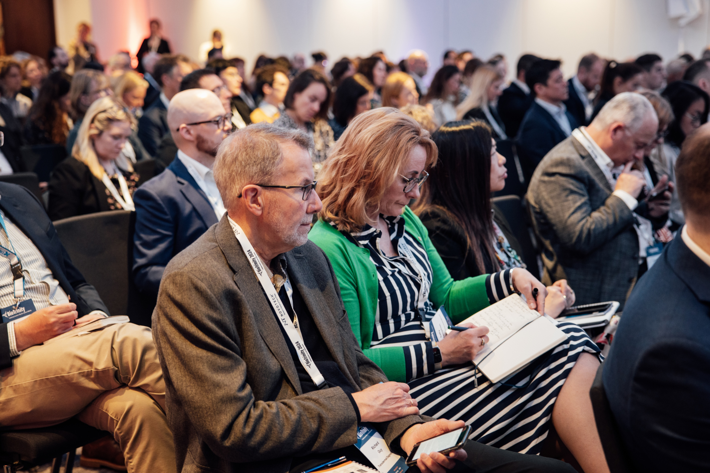 Photograph of a seated audience watching a presentation at the 2024 BioTrinity conference.