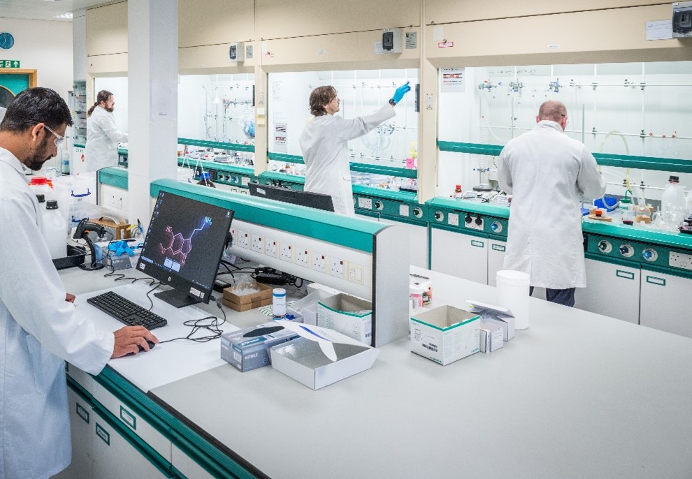 Photograph of scientists working in a laboratory.